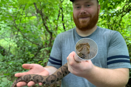 Photo: Bobby Kwait holds an eastern copperhead snake