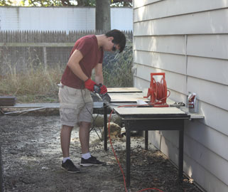 student working on a bat house