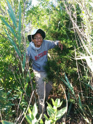 Carlos Olivares walking through plants