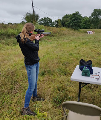 Photo: Tess Bender shooting a rifle at rifle training